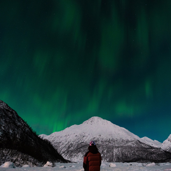 PWSC student loooks up at the northern lights as they appear over Valdez, Alaska