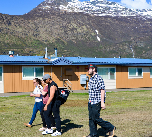 Prince William Sound College students walking infront of student housing in Valdez, Alaska